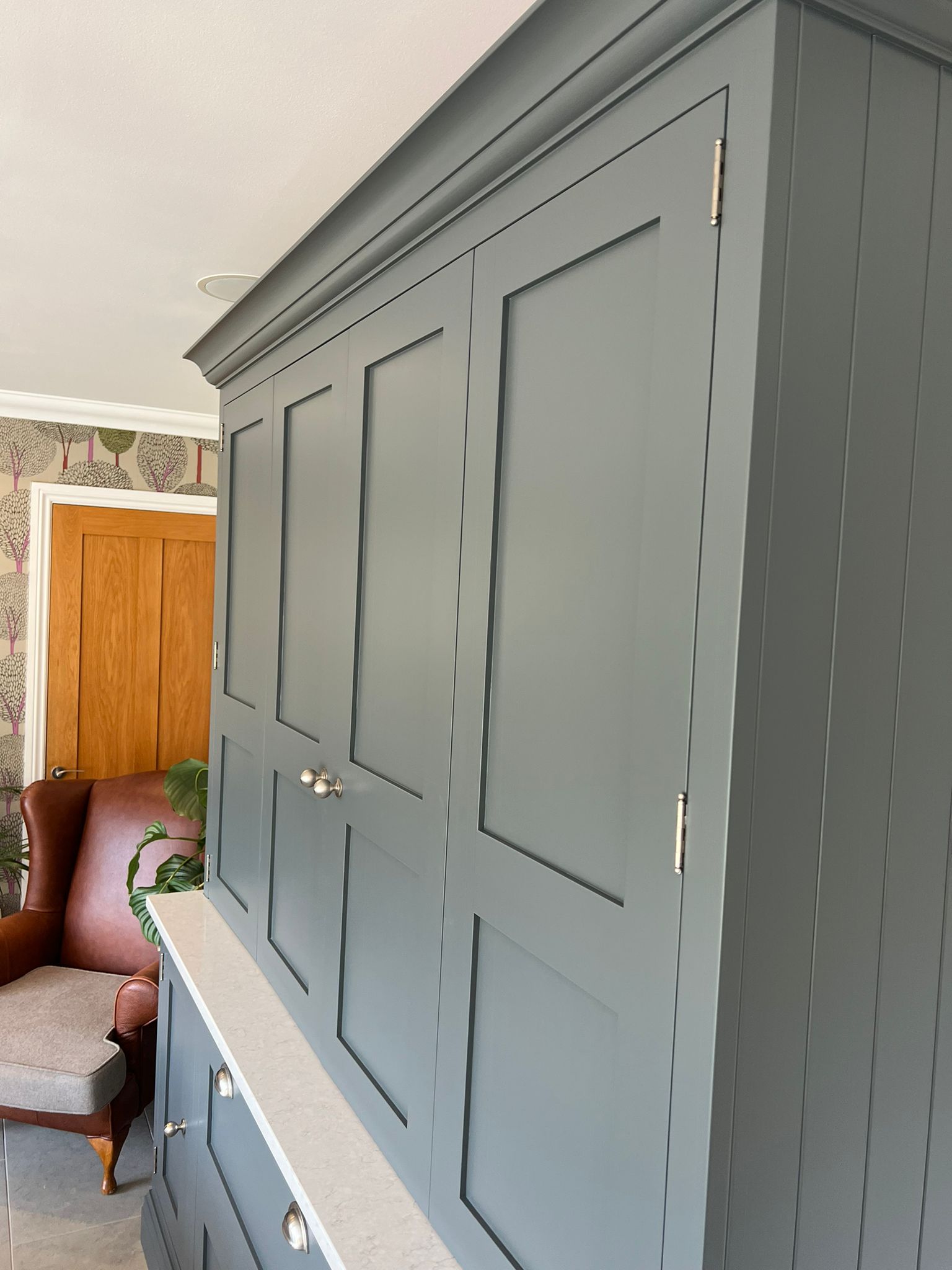 Close-up detail of professionally painted kitchen cabinets showing a smooth durable finish