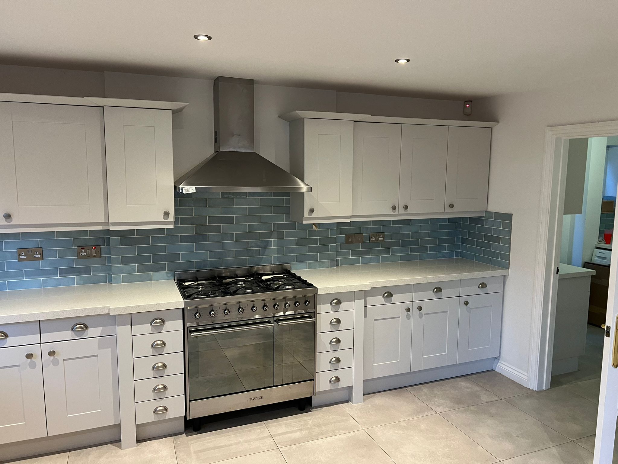 Kitchen after repainting cabinets with a refreshed painted finish