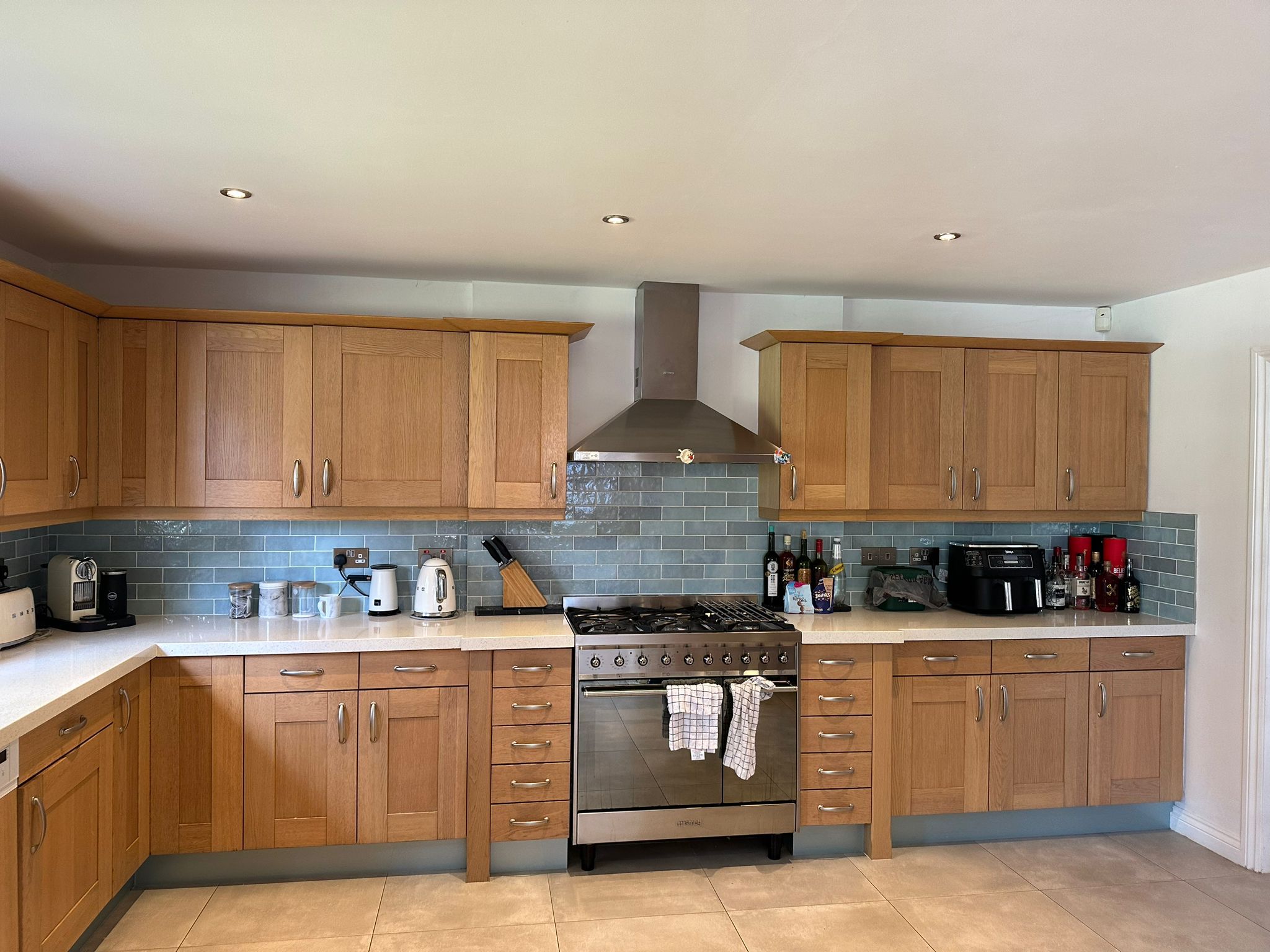 Kitchen before refurbishment with original cabinets and dated finish