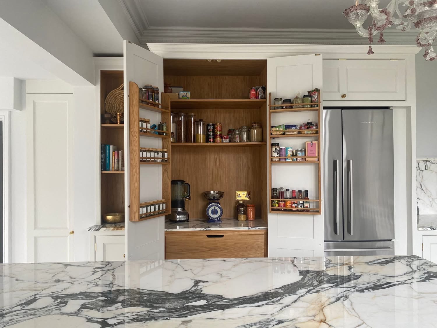 Kitchen cabinetry with doors removed during preparation for hand painting