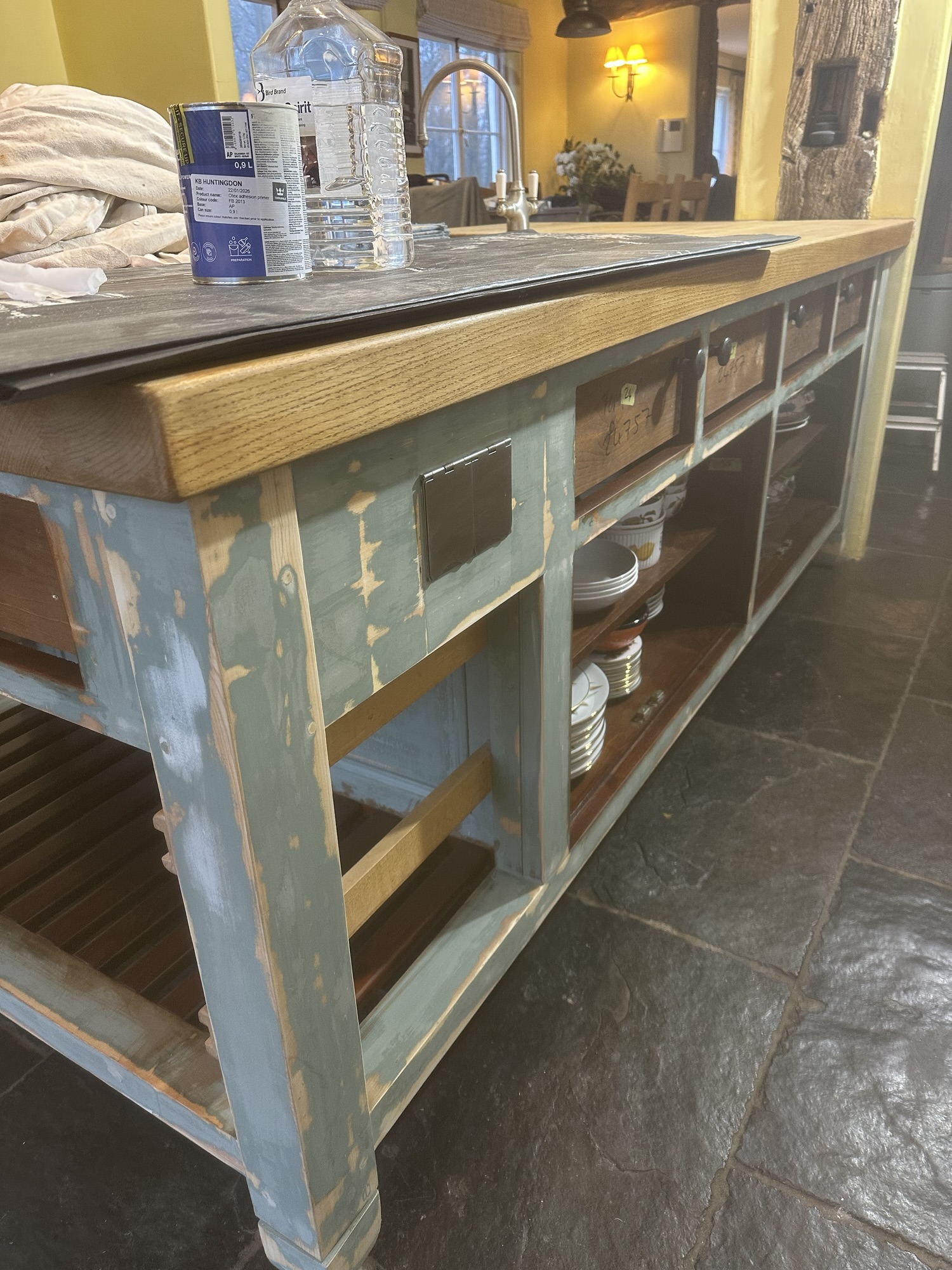 Kitchen cabinet preparation stage with doors removed ready for professional painting