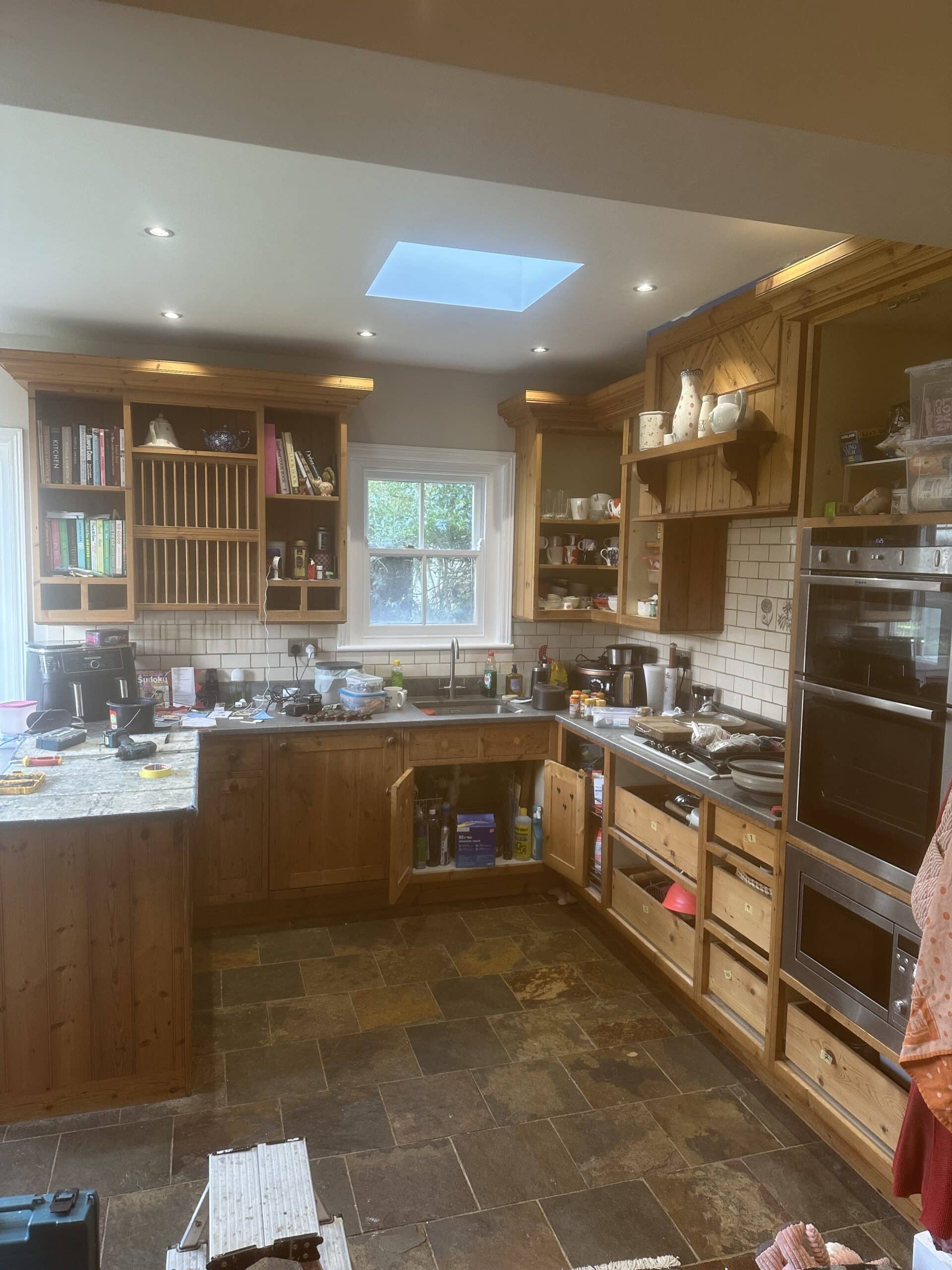 Natural reclaimed pine kitchen cabinetry before specialist refurbishment