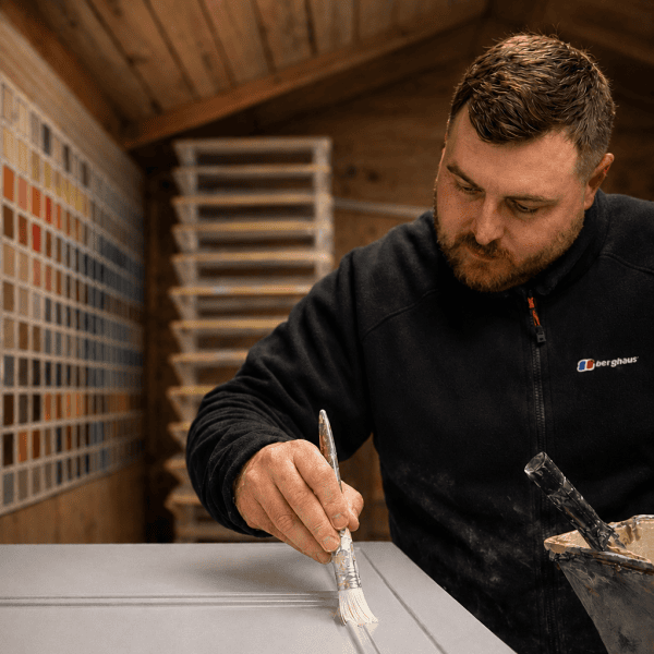 Paul Barber Jnr hand painting bespoke kitchen cabinetry